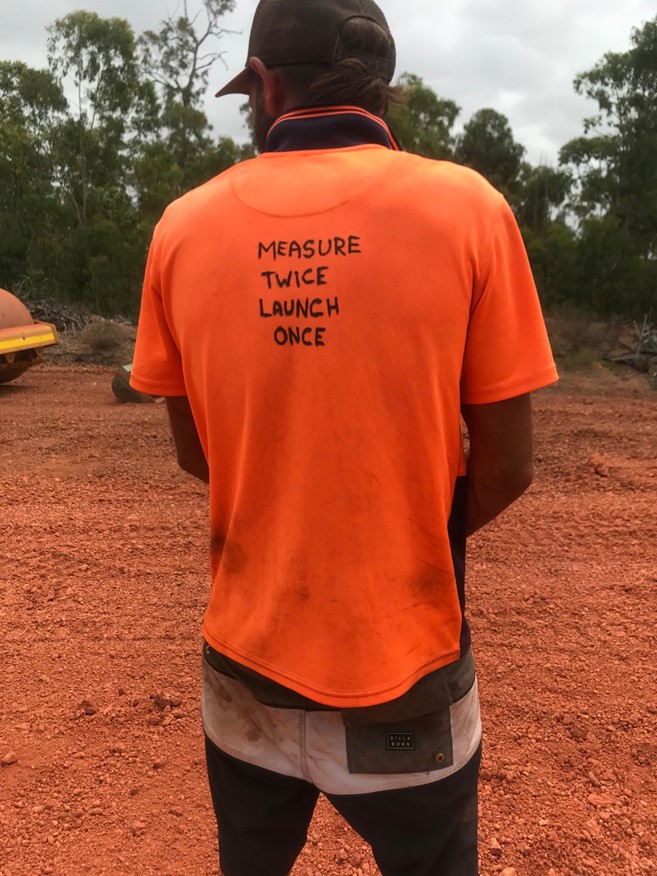 Man wearing top saying Measure twice, launch once.